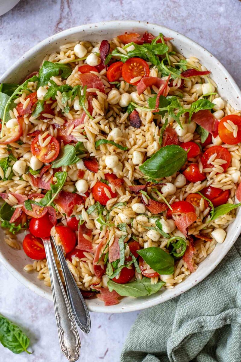 caprese pasta salad with prosciutto closeup top view